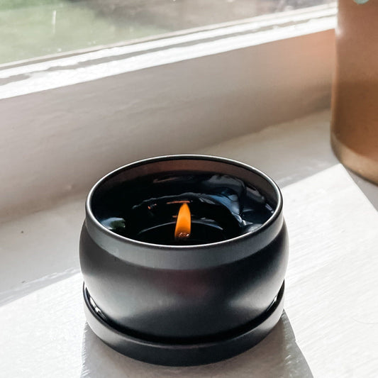 Charcoal votive candle on windowsill